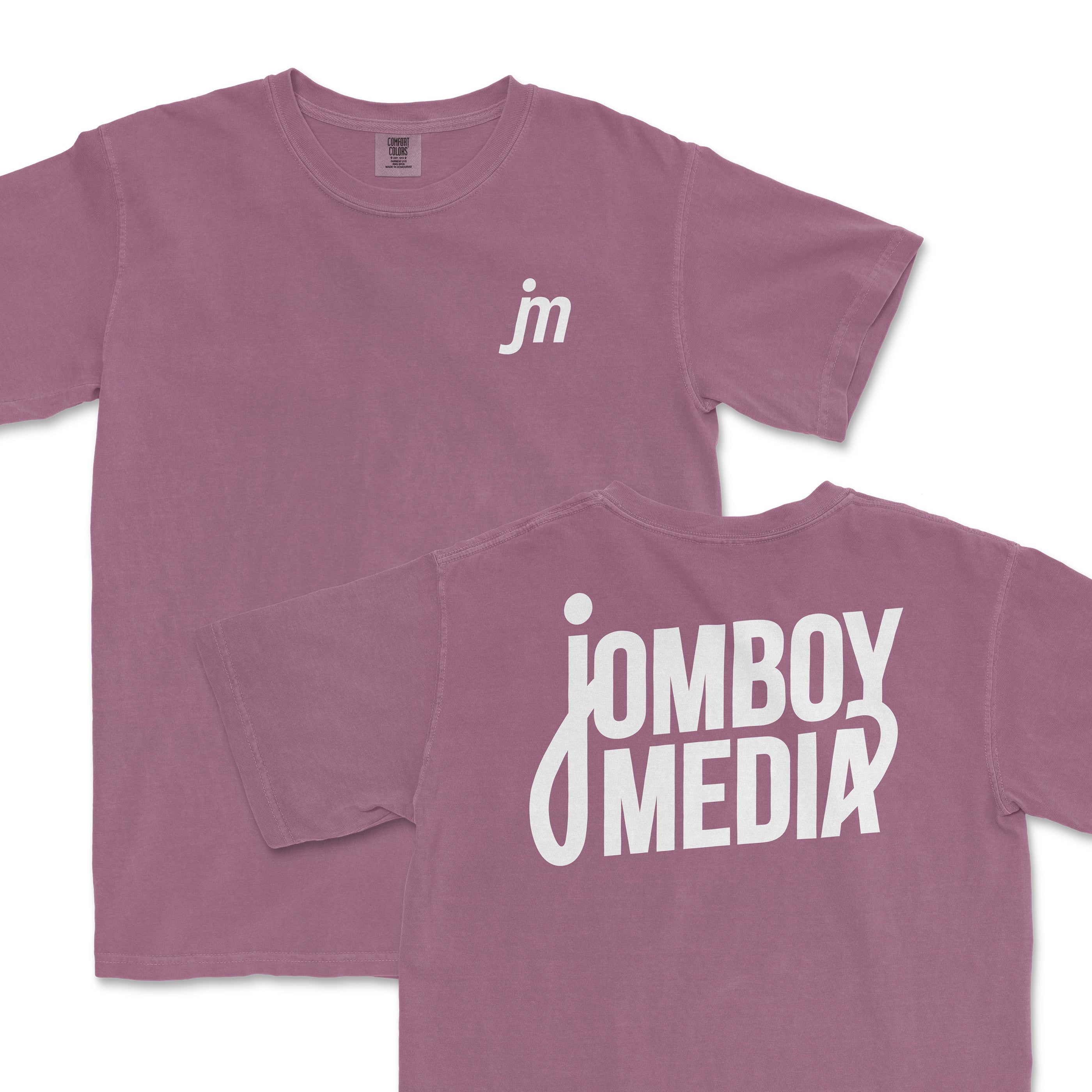 JM Essentials '25 Logo Tee in dusty rose featuring front logo and bold back design for Jomboy Media fans.