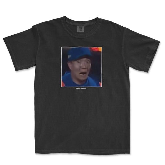 Black Comfort Colors T-shirt featuring a surprised expression of Kodai Senga, with a pixelated photo and small text below.
