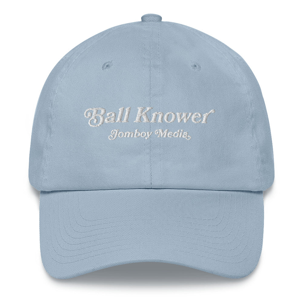 Light blue dad hat with "Ball Knower" and "Jomboy Media" embroidered in white on the front.