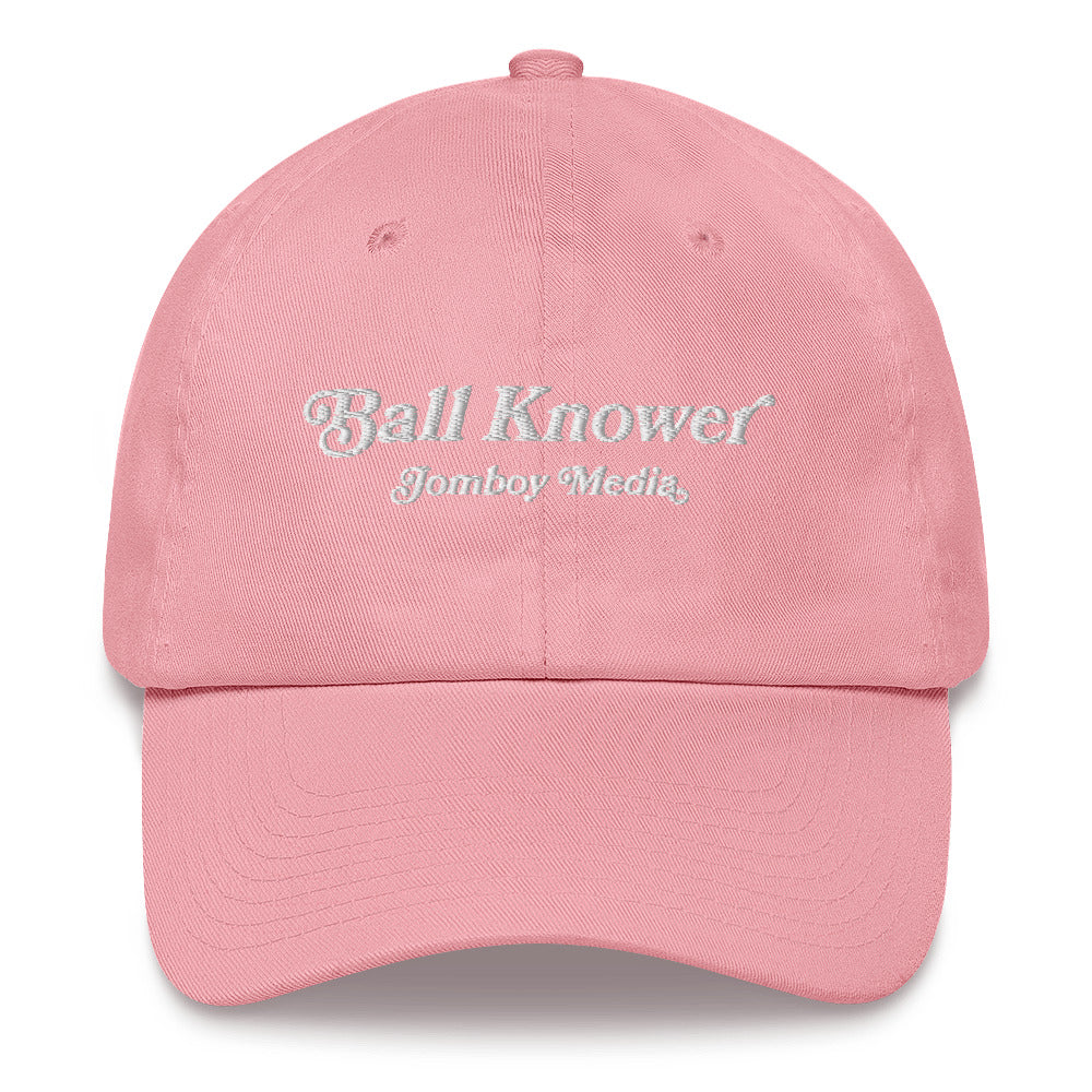 Pink dad hat with "Ball Knower" and "Jomboy Media" embroidered in white on the front.
