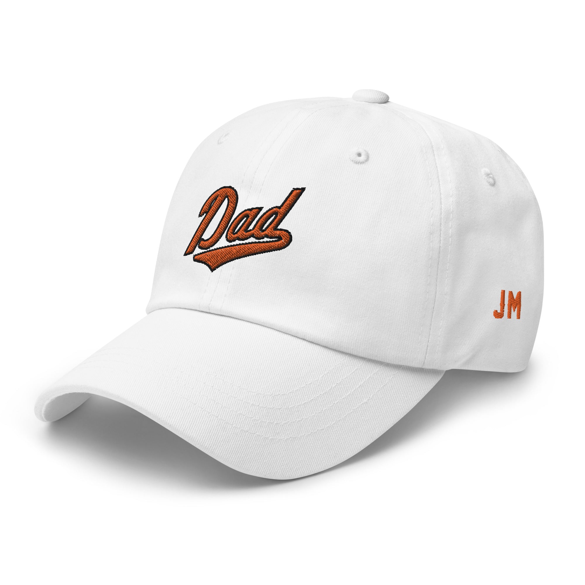 White dad hat with "Dad" embroidered in orange and black on the front, and "JM" initials on the side.
