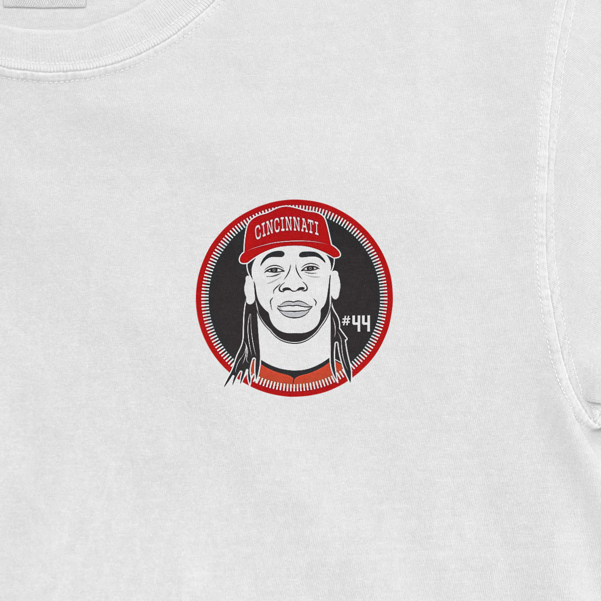 Elly De La Cruz graphic on a Comfort Colors white T-shirt featuring a stylized portrait with "CINCINNATI" hat and "#44" number.