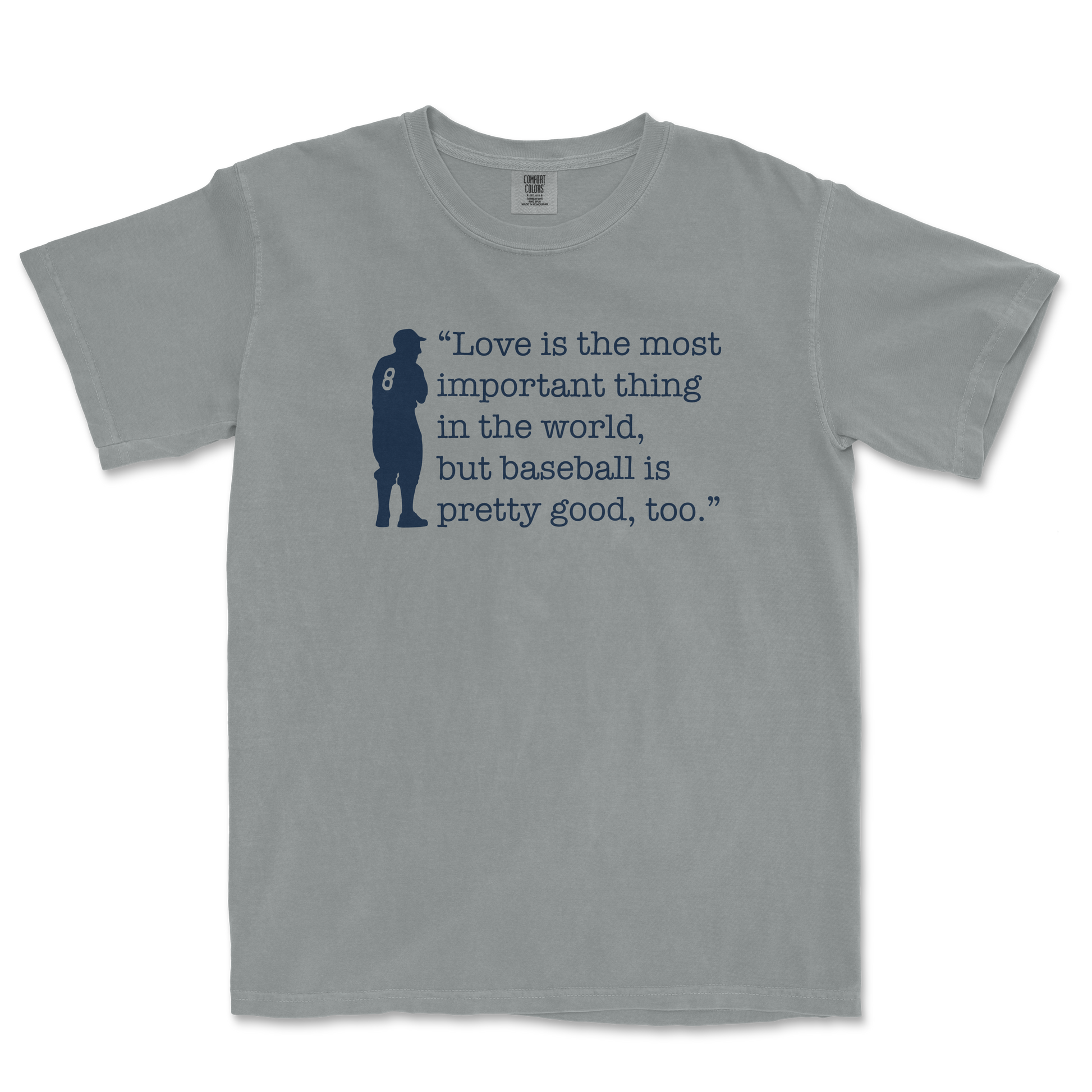 Gray Comfort Colors T-shirt featuring a navy silhouette of a baseball player and the quote: "Love is the most important thing in the world, but baseball is pretty good, too.