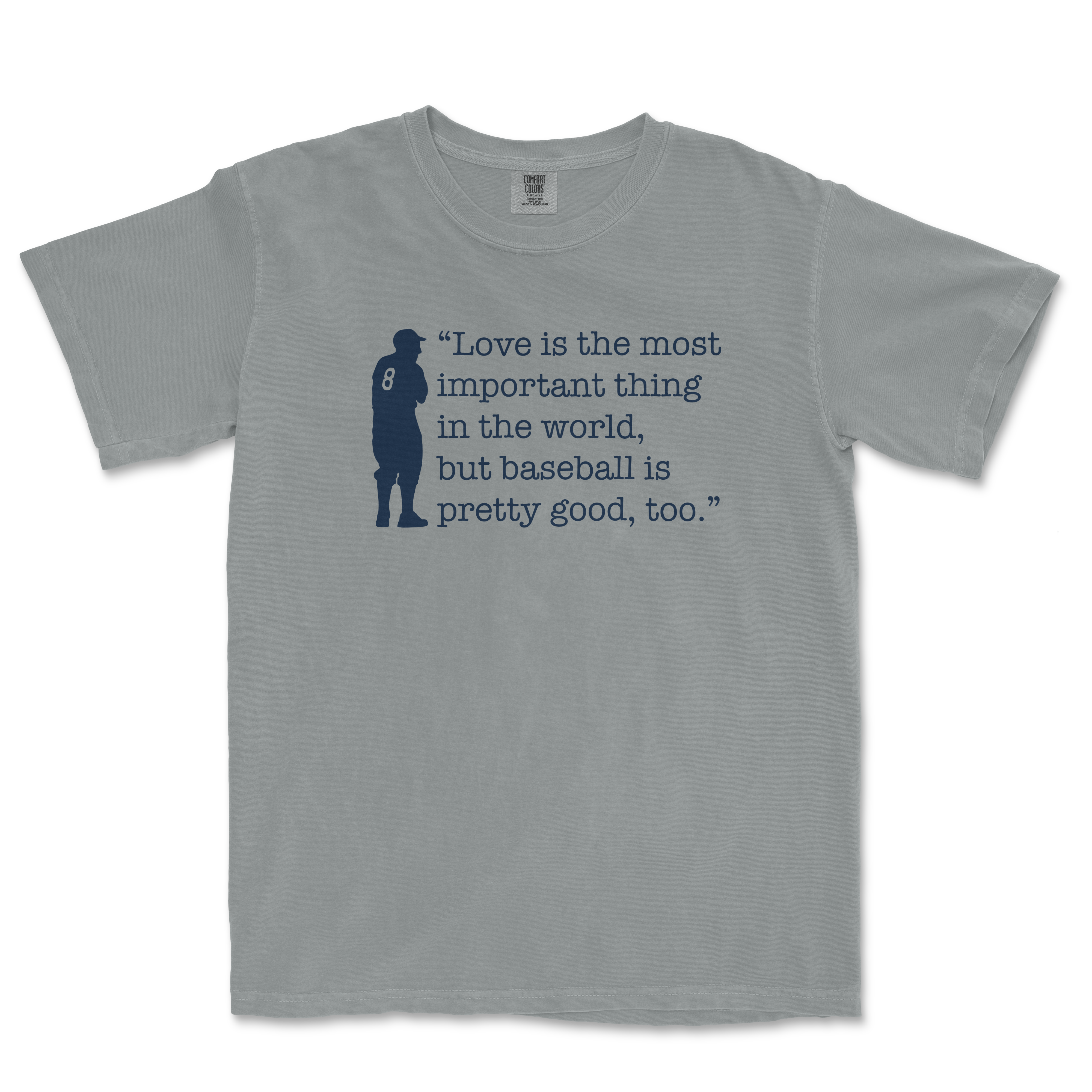 Gray Comfort Colors T-shirt featuring a navy silhouette of a baseball player and the quote: "Love is the most important thing in the world, but baseball is pretty good, too.