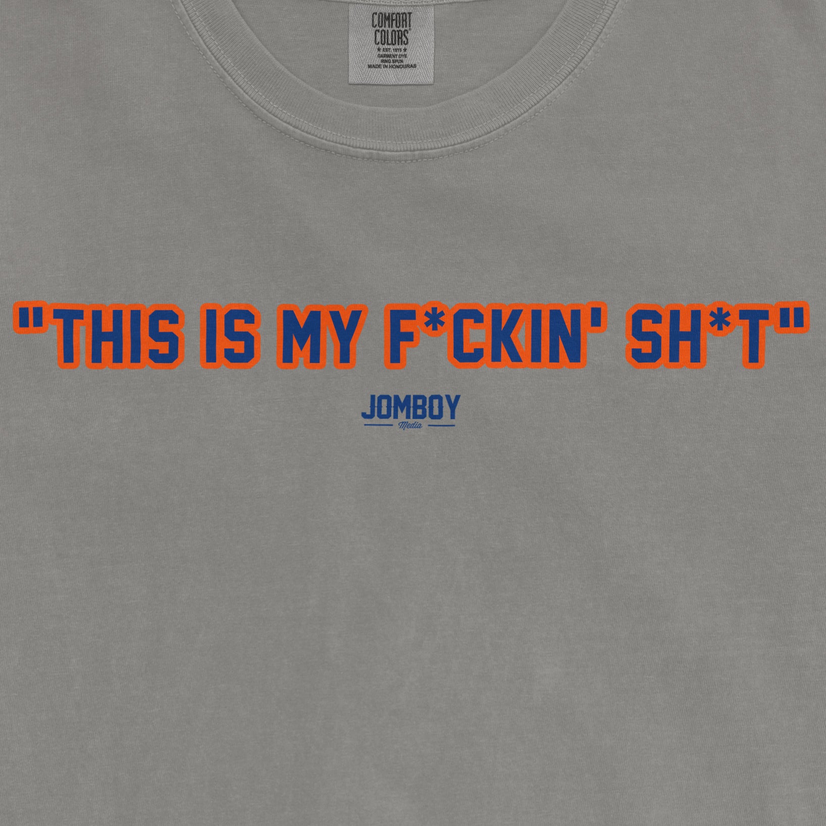 Gray T-shirt with bold orange and blue text reading "This is my f*ckin' sh*t" and a small blue "JomBoy Media" logo below.