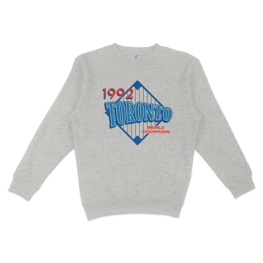 Gray crewneck sweatshirt featuring a vintage Toronto 1992 World Champions graphic with blue and red text and design elements.