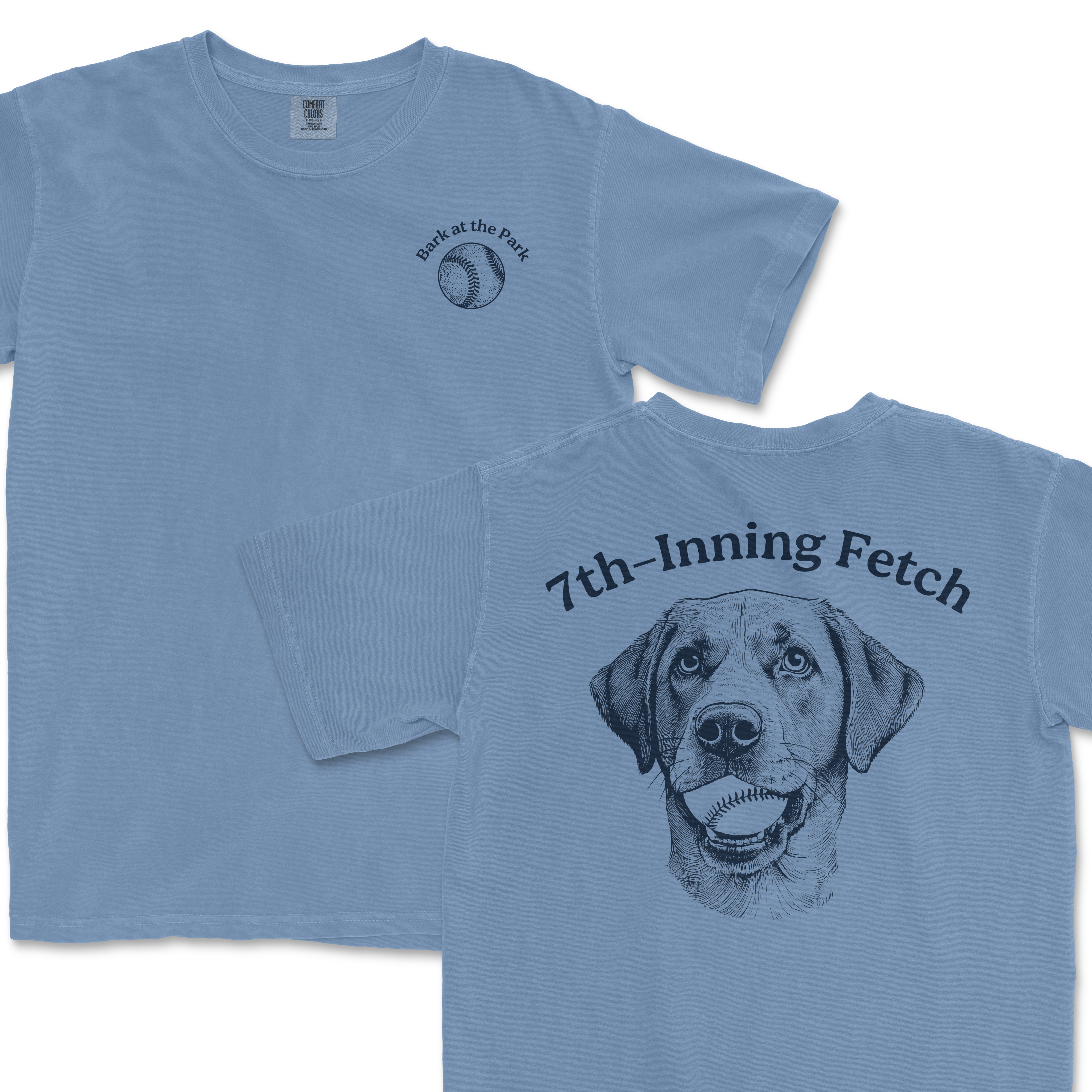 Light blue Comfort Colors T-shirt featuring a "Bark at the Park" baseball graphic on the front and a large dog illustration with a baseball in its mouth on the back, with "7th-Inning Fetch" text above.
