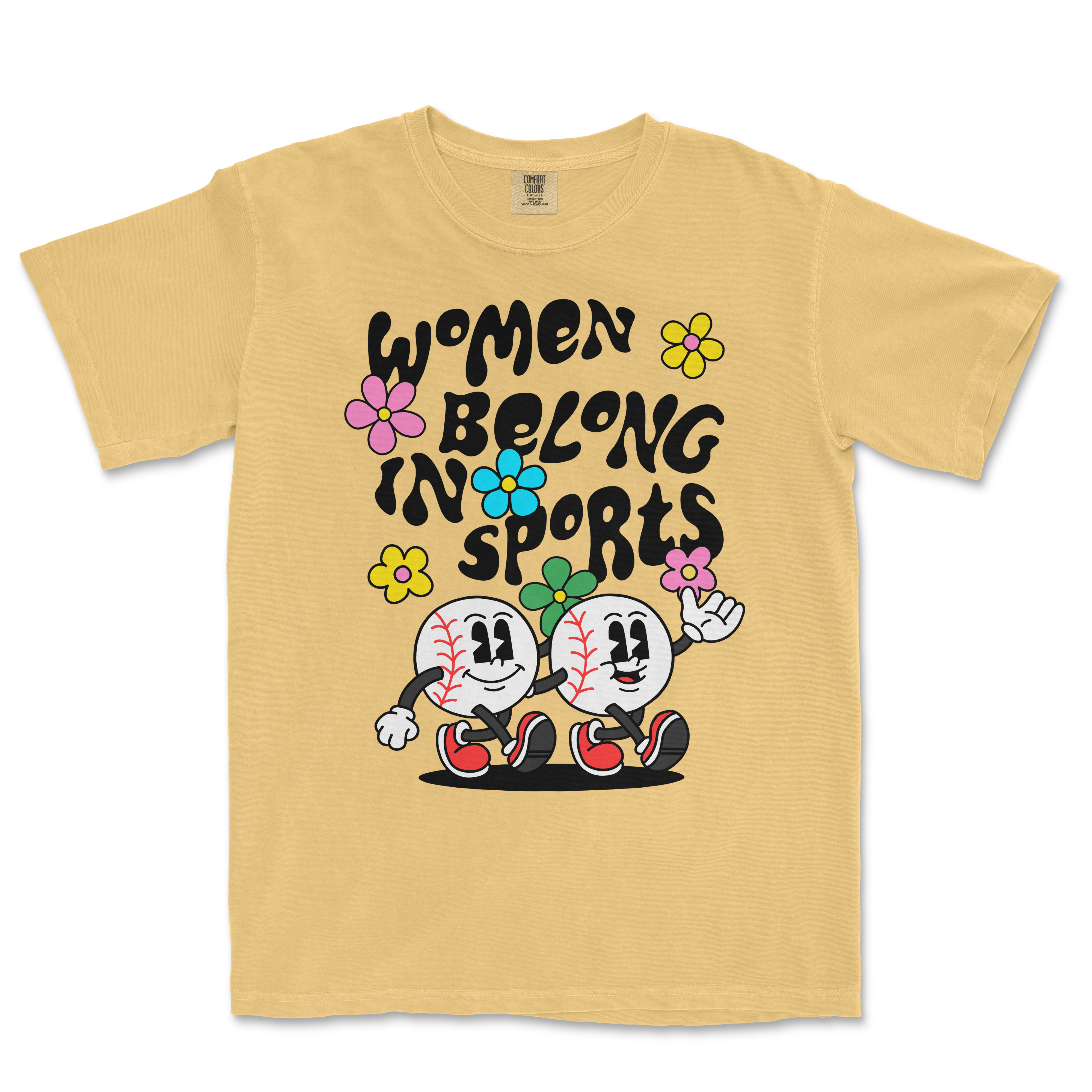 Beige T-shirt featuring cartoon baseball characters with flowers and the text "Women Belong in Sports" in bold black letters.