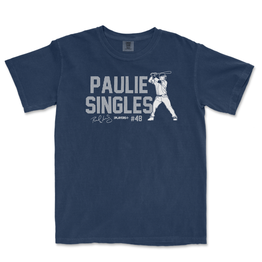 Blue T-shirt featuring a graphic of a baseball player swinging a bat, with "Paulie Singles" text and signature design.