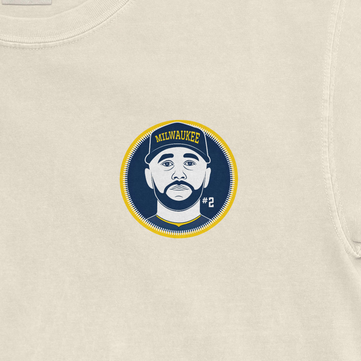 Beige Comfort Colors tee featuring a Milwaukee-themed graphic of a man with a cap, beard, and the number 2.