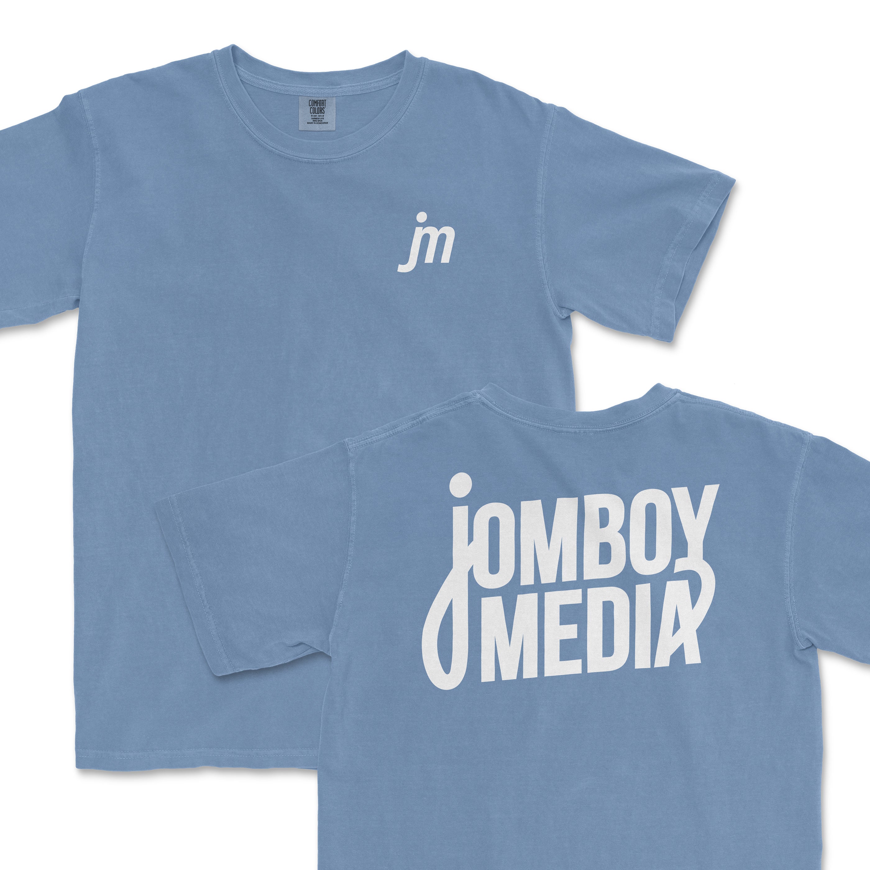 Light blue JM Essentials '25 Logo Tee featuring a small logo on the front and bold Jomboy Media branding on the back.