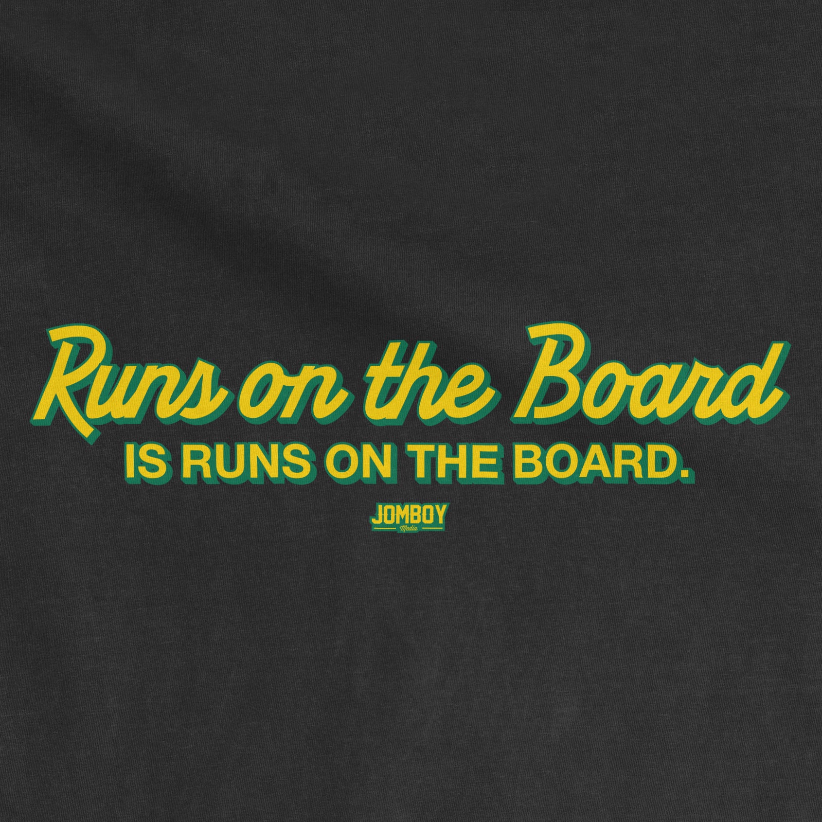 Black T-shirt with green and yellow text that reads "Runs on the Board is Runs on the Board" and a small "JomboY" logo below.