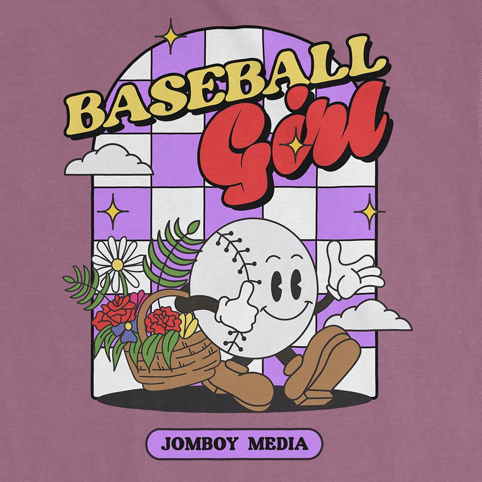 Comfort Colors tee featuring a playful cartoon baseball character with flowers, clouds, and "Baseball Girl" text.